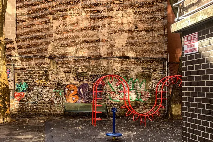 a playground in front of a brick wall